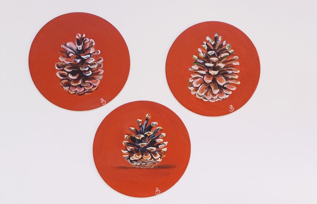 peinture de pommes de pin sur fond terracotta